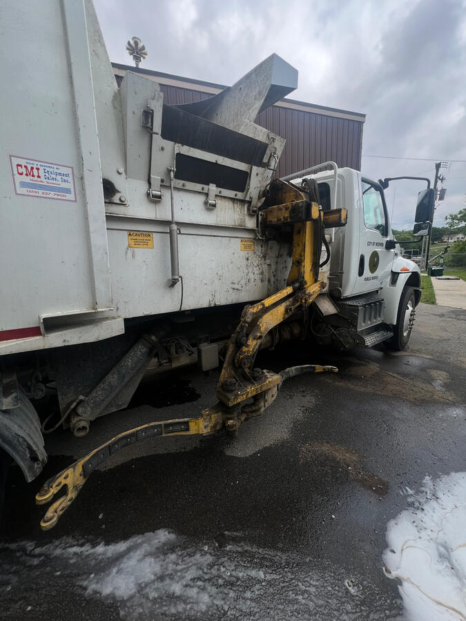 Dirty greasy trash truck washing by shiny side up mobile truck wash
